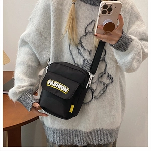 Black canvas crossbody bag with FASHION patch and adjustable strap for women