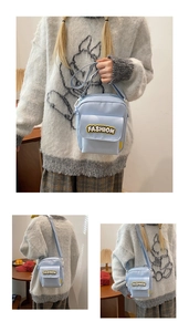 Detail of light blue casual crossbody bag with fashion patch and adjustable strap