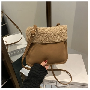 Detail of plush sherpa and brown suede crossbody bucket bag with adjustable strap