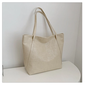 Detail shot of cream crocodile embossed texture on large minimalist tote bag