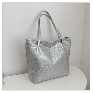 Detailed view of silver crocodile pattern texture on a large capacity tote bag