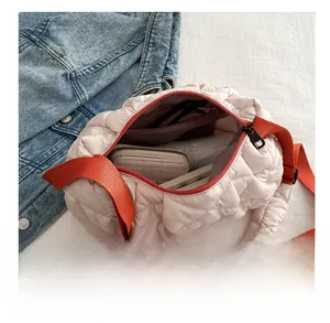 Detailed interior view of a large quilted crossbody bag showing daily storage capacity