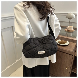 Quilted black crossbody bag for women with fashion label and adjustable wide strap