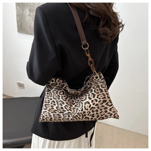 Chic leopard print tote bag with brown leather strap and amber acrylic chain detail