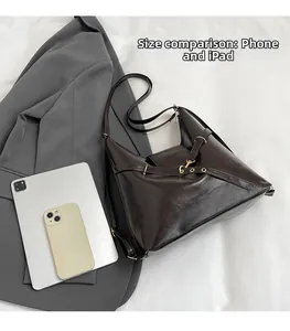 Detailed size comparison of the dark brown retro tote bag with an iPad and smartphone