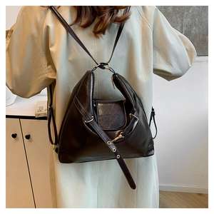 Versatile black leather tote bag for women showing a dual shoulder and backpack design