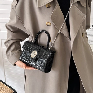 Glossy black crocodile pattern handbag with silver oval twist lock and chain strap