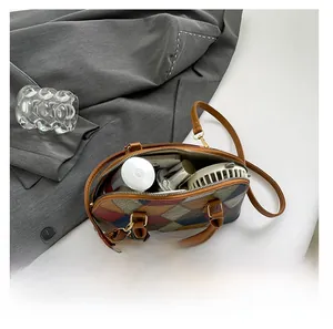 Top view of spacious geometric patchwork bag showing interior storage for daily items