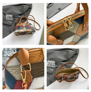 Detail view of multicolored geometric splicing texture and golden double zipper on shell bag