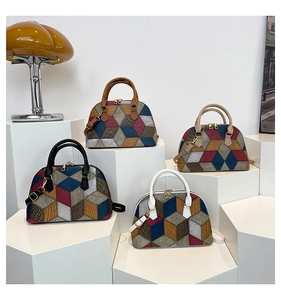 Detailed view of color-block shell bags with crocodile texture and metal zippers