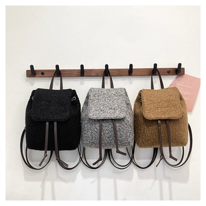 Lambswool mini bucket backpacks in black, grey, and brown with leather straps
