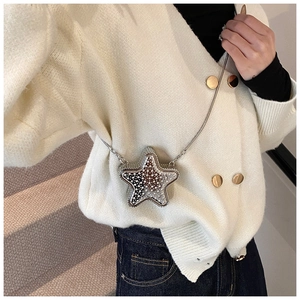 Star-shaped mini crossbody bag with pearl bead detailing and long metal chain on model