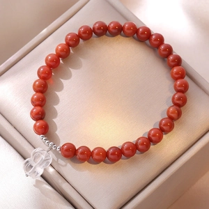 Elegant S925 sterling silver bracelet with red agate beads and a clear lotus pendant