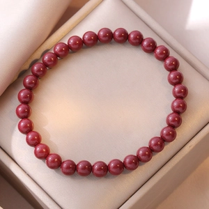 Natural cinnabar round bead bracelet displayed in a premium satin jewelry gift box