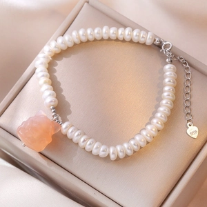 S925 silver freshwater pearl bracelet with pink agate fox charm on beige jewelry box