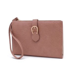 Dettaglio di pochette rosa in finta pelle con fibbia a ferro di cavallo e grana fine