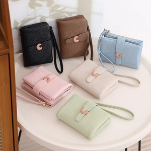 Short women's pebbled leather wallets in six colors with metal C buckle and wristlet