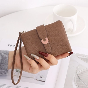 Brown lychee grain leather short wallet with pink C-buckle and matching hand strap