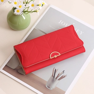 Détail du portefeuille rouge pour femmes avec boucle dorée et motif matelassé