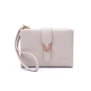Detail of beige litchi grain short wallet with metal buckle and leather wristlet strap