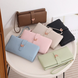 Detailed display of long multi-color pebbled leather wallets with wristlets and metal clasps