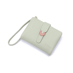 Close-up of mint green litchi texture leather wallet with pink C-shape buckle detail