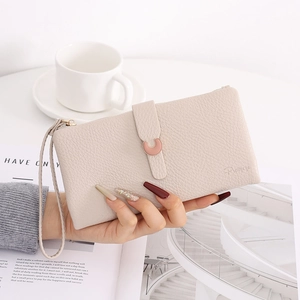 Close-up of beige litchi pattern long wallet with elegant rose gold metal C-buckle