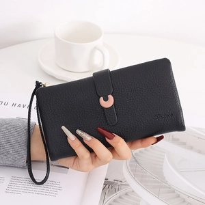 Close-up of a black lychee-textured long wallet featuring a pink C-shaped metal buckle