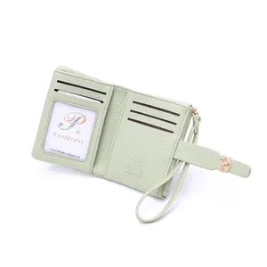 Detail view of mint green PU leather wallet interior with card slots and wristlet zip pocket