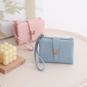 Detail of short leather wallets with lychee pattern and rose gold U-shaped metal buckle