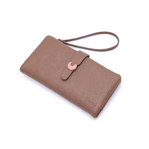 Close-up of brown litchi pattern leather wallet featuring a gold C-shaped metal clasp