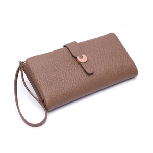 Detail view of brown pebbled leather long wallet with elegant rose gold C-shaped buckle