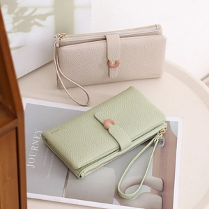 Detail of lychee pattern leather wallets with silver C-buckle and wrist straps