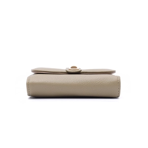 Detail view of khaki pebbled leather texture and precise stitching on the wallet base