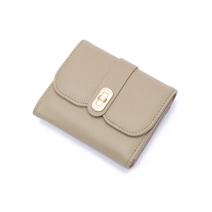 Detail of khaki tri-fold wallet with lychee texture and gold rotating buckle lock