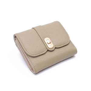Detail of khaki pebbled leather tri-fold wallet featuring a gold lucky twist lock closure