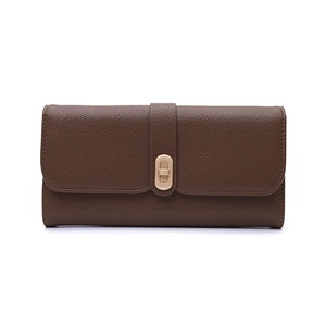 Detail of deep brown long wallet with litchi grain texture and gold metal buckle
