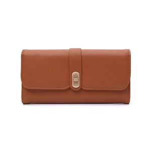 Detail of caramel lychee grain leather wallet featuring a gold-tone twist lock closure