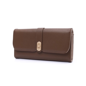Detail of dark brown lychee grain leather wallet with a light gold metal twist lock