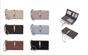 Detailed view of women's long purse showing multiple card slots and leaf metal clasp
