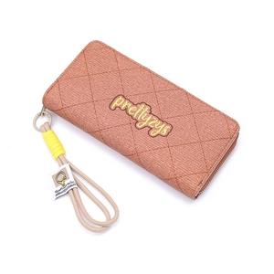 Macro view of brick red quilted leather long wallet with wristlet strap and logo