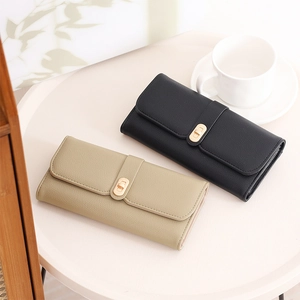 Detailed view of women's long wallet featuring lychee texture and gold metal clasp