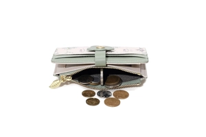 Detail view of floral flap buckle and golden leaf zipper puller on a card wallet