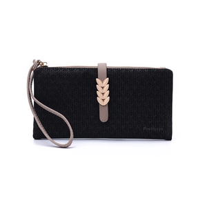 Close-up of golden leaf metal clasp and textured black surface on this wallet
