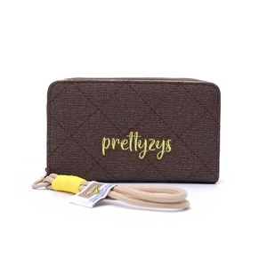 Close-up of quilted dark brown wallet with yellow embroidery and woven wrist strap