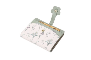 Detail of floral wallet featuring daisy patterns and a petal-shaped gold buckle