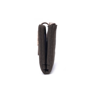 Side view of dark brown faux leather folding wallet showing layered texture and metal clasp