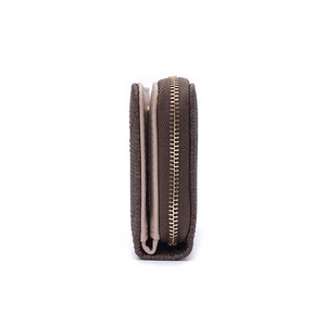 Detail view of a brown pebbled leather wallet featuring a durable metal zipper closure