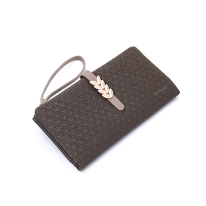 Close-up of dark brown textured leather wallet with a decorative metal leaf buckle