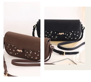 Detail of color-block crossbody bag with leaf-shaped metal clasp and printed pockets